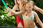 Girl (7-9) Playing Ping-Pong with Mother.