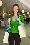 Girl Holding Shopping Bags in Boutique, portrait