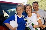 Parents with daughter (13-17) holding soccer trophy, portrait