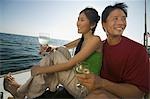 Couple dinking white wine on boat