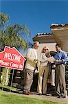 Couple with estate agent, low angle view