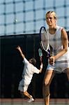 Tennis Player standing,  holding racket near net, Waiting For doubles partner to Serve, low angle view