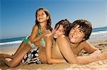 Children in swimwear playing beach