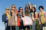 Young women with shopping bags, outdoors, (portrait)