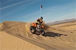 Man riding quad bike in desert