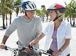 Senior couple on bicycles on tropical beach