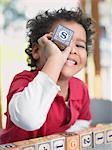 Boy playing with alphabet blocks, portrait