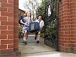 Elementary students running out through school gate