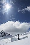 Mountain climber standing on snowy slope