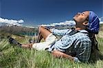 Man lying in field feeling sun