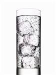Glass of water with ice cubes on white background