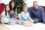 Happy Family in Front of Christmas Tree, portrait