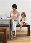 Mother showing daughter laptop