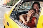 Couple in yellow taxi cab