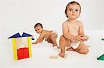 Baby Boy and Girl Playing With Building Blocks