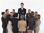 Group of Businesspeople Staring at Tall Man