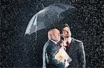 Businessmen Watching Rain from Under Umbrella