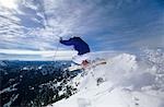 Skier jumping on mountain top, Hitting the Slopes