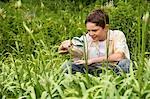 Boy Looking at Insects with Magnifying Glass