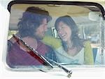 Young couple in van, view through window screen