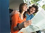 Young Couple Reading Map on Road Trip