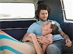 Affectionate Young Couple Relaxing in Camper Van
