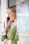 Business woman using mobile phone in office