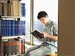 College Student Reading in Library