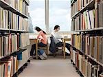 Teenagers doing homework in library