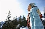 Couple embracing in mountains, side view, low angle view