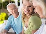 Three people sitting on verandah