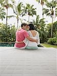 Affectionate Young Couple Relaxing in Garden