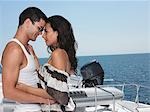 Young couple embracing on yacht, profile