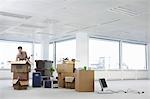 Woman with Cardboard Boxes in Empty Office Space