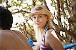 Young woman in sun hat, outdoors, head and shoulders