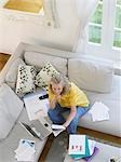Woman using laptop sitting on sofa, elevated view