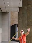 Woman throwing javelin outside building