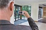 Real estate agent photographing new property