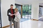 Couple reading brochure in new property