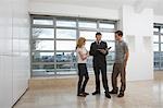 Real estate agent showing couple new apartment