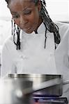 Female chef cooking in kitchen