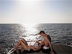 Couple Sunbathing on Boat