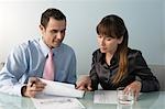 Business man and woman working at table in office