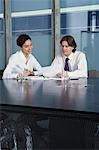 Business man and woman working at table in conference room
