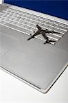 Shadow of jumbo jet over apple macintosh keyboard