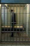 Man walking in prison cell, motion blur