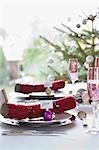 Christmas crackers with name tags on dining table
