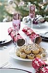 Christmas crackers and mince pies on dining table