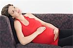 Pregnant woman relaxing on sofa