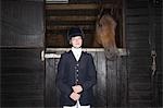 Porträt des weiblichen Reiten Reiter mit Pferd im Stall